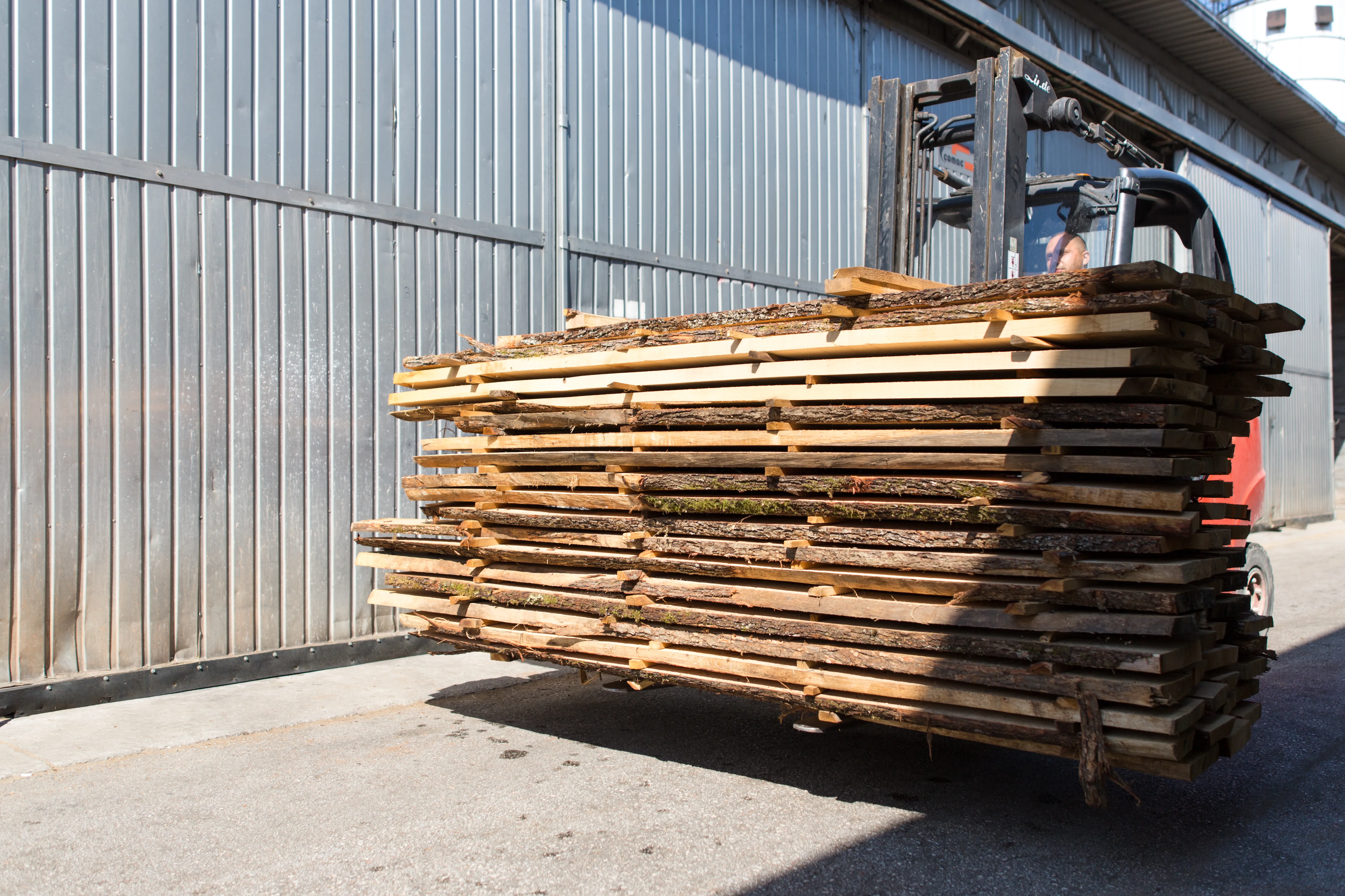 Stacked rough-sawn lumber on a forklift outside the Ilijaš sawmill.