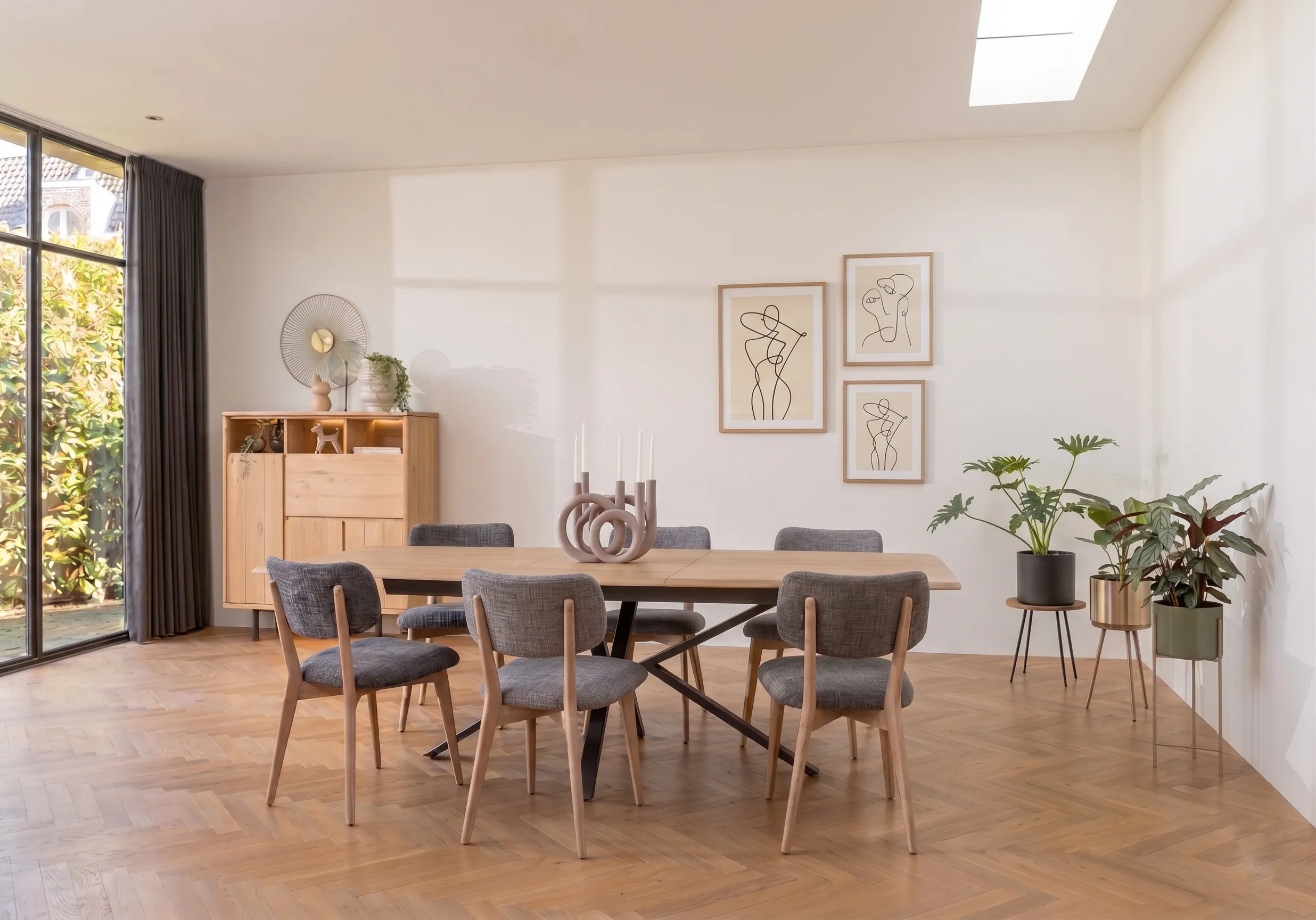 Light dining room with chairs on solid oak frames around an oak extension table.