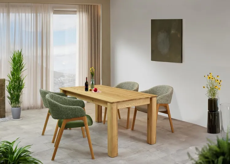 Solid oak extension table with curved-back chairs on oak legs.